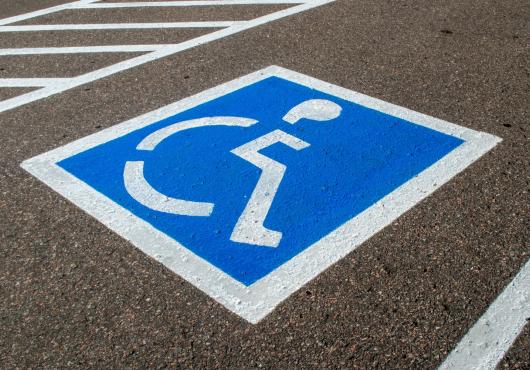 A parking space noted with a handicap parking emblem