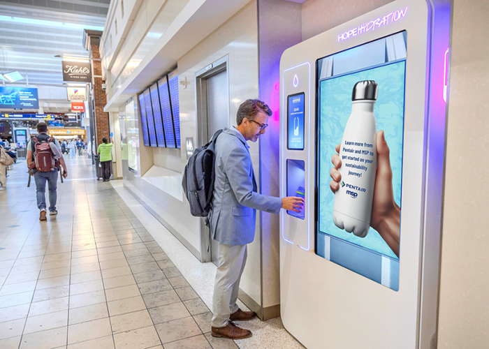 Passenger refilling water bottle